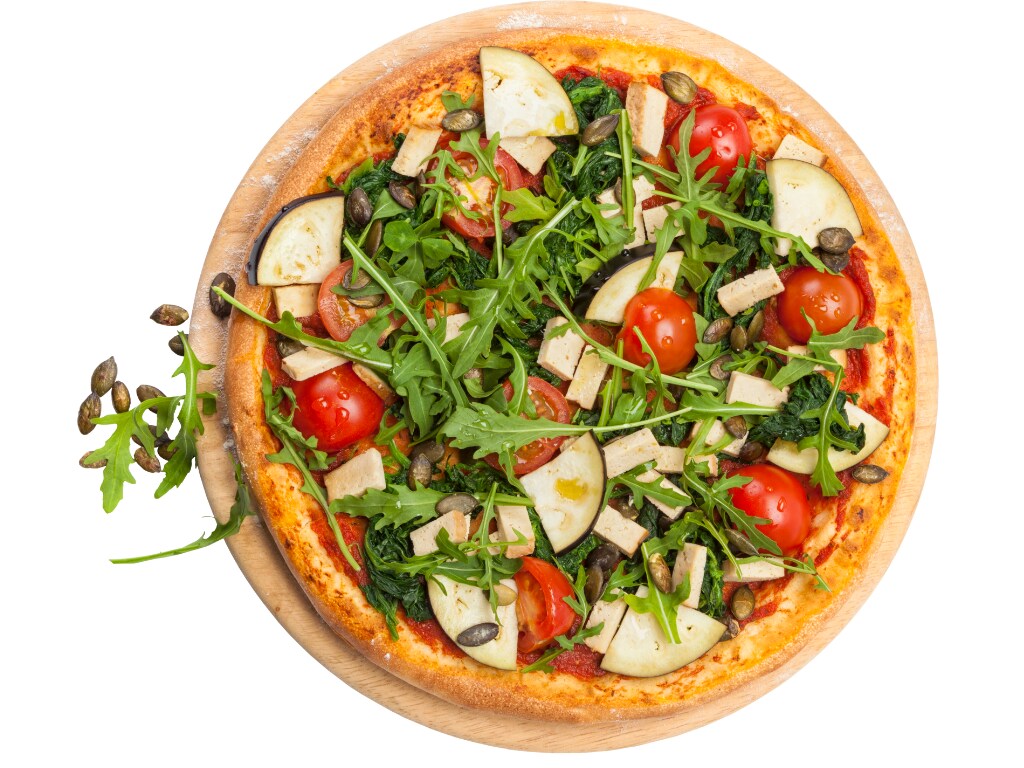 Vegetarian pizza with tofu, eggplant, tomatoes, rocket salad, spinach, and pumpkin seeds