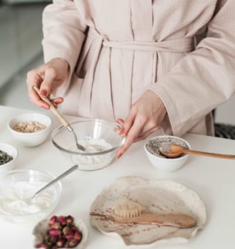 alt="DIY natural honey and oatmeal face cleanser in a glass bowl with a wooden spoon"